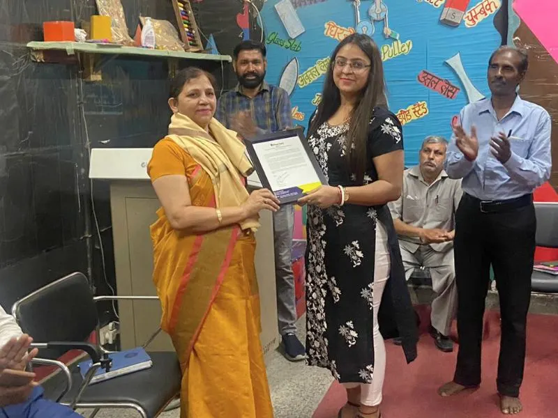 PLANCARE team receiving recognition from school principal and MCD officials