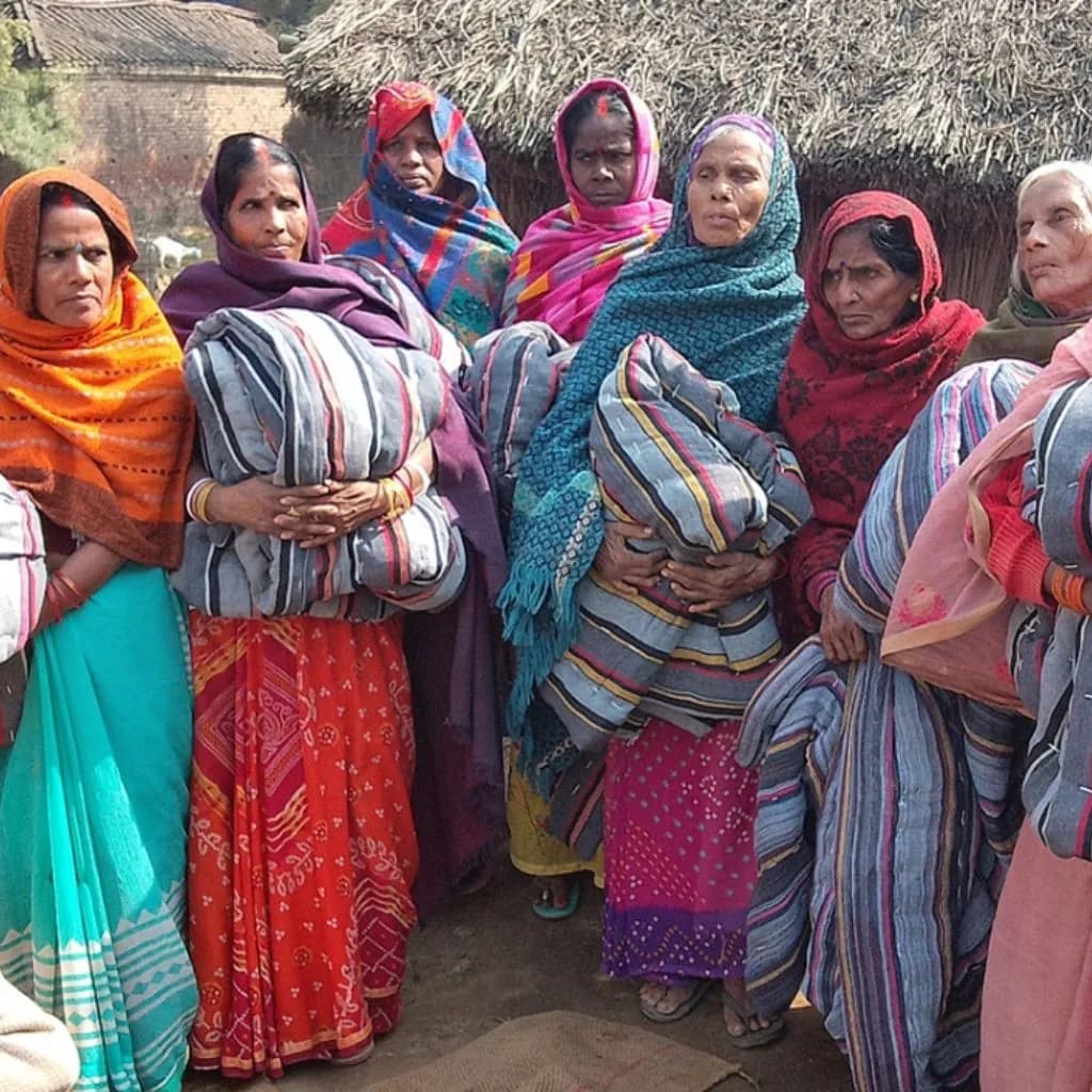 PlanCare volunteers distributing blankets to homeless individuals in Delhi
