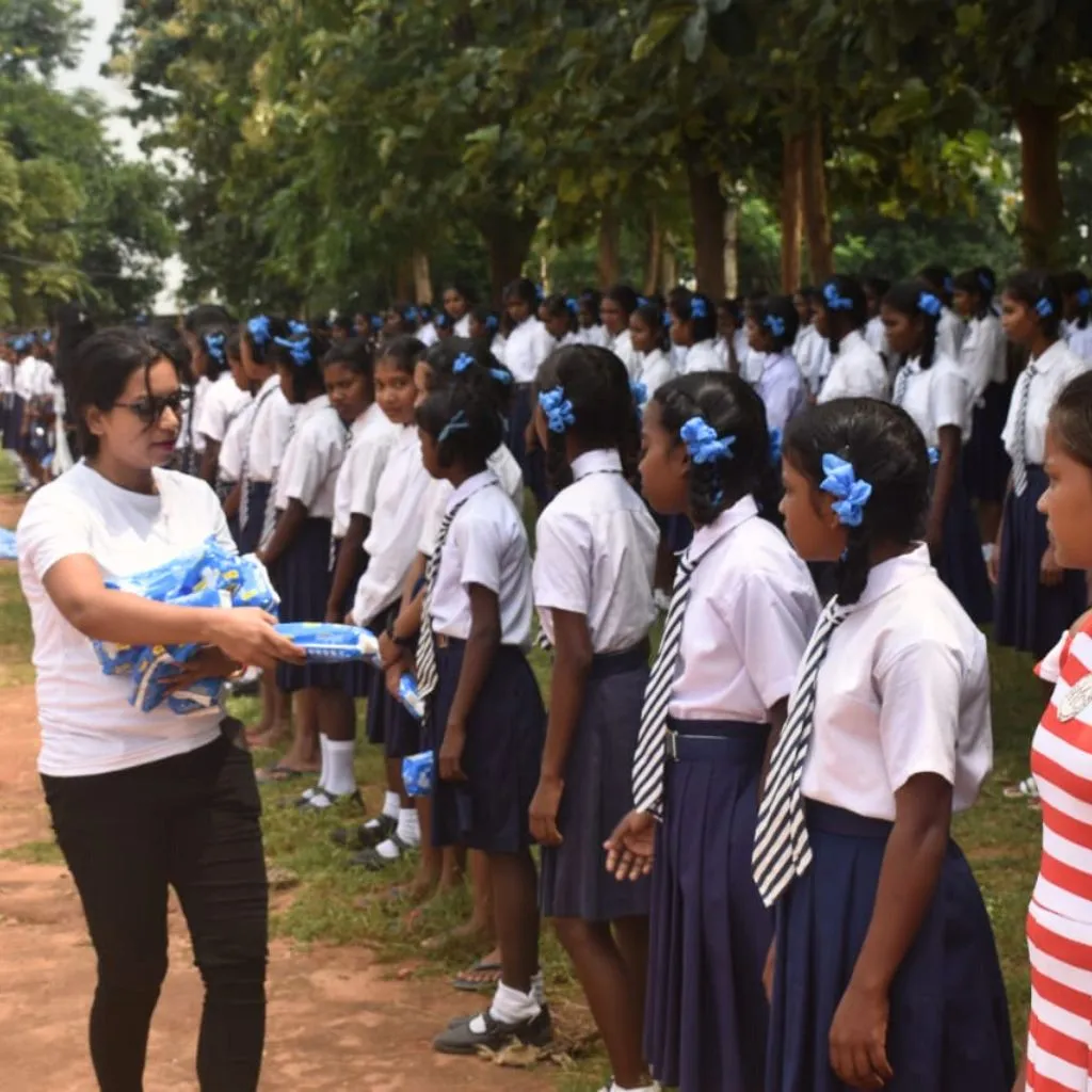 Rural schoolgirls receiving sanitary pads during PlanCare’s awareness drive