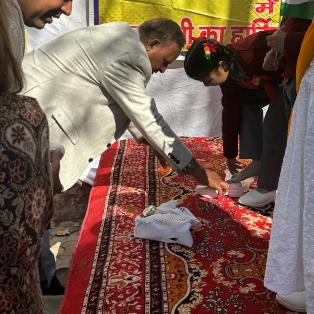 PlanCare volunteers measuring children for proper shoe size