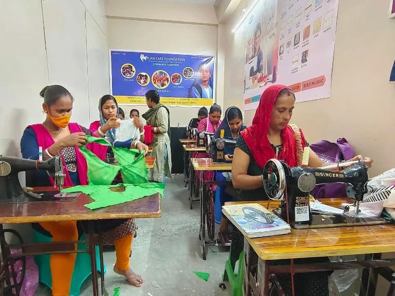Women learning sewing skills at Plan Care Foundation's Sewing Training Center