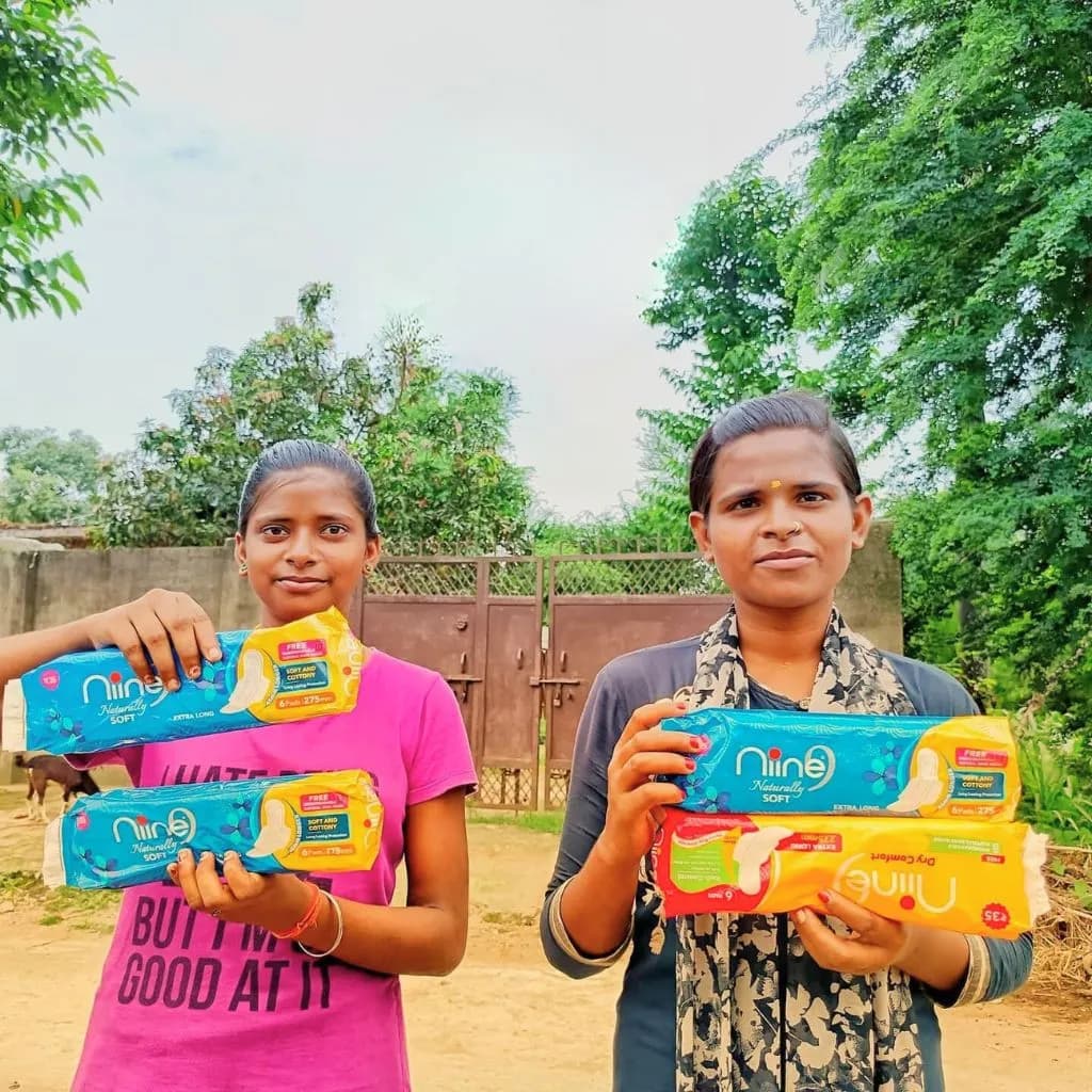 Village girls receiving menstrual hygiene kits during NGO outreach event