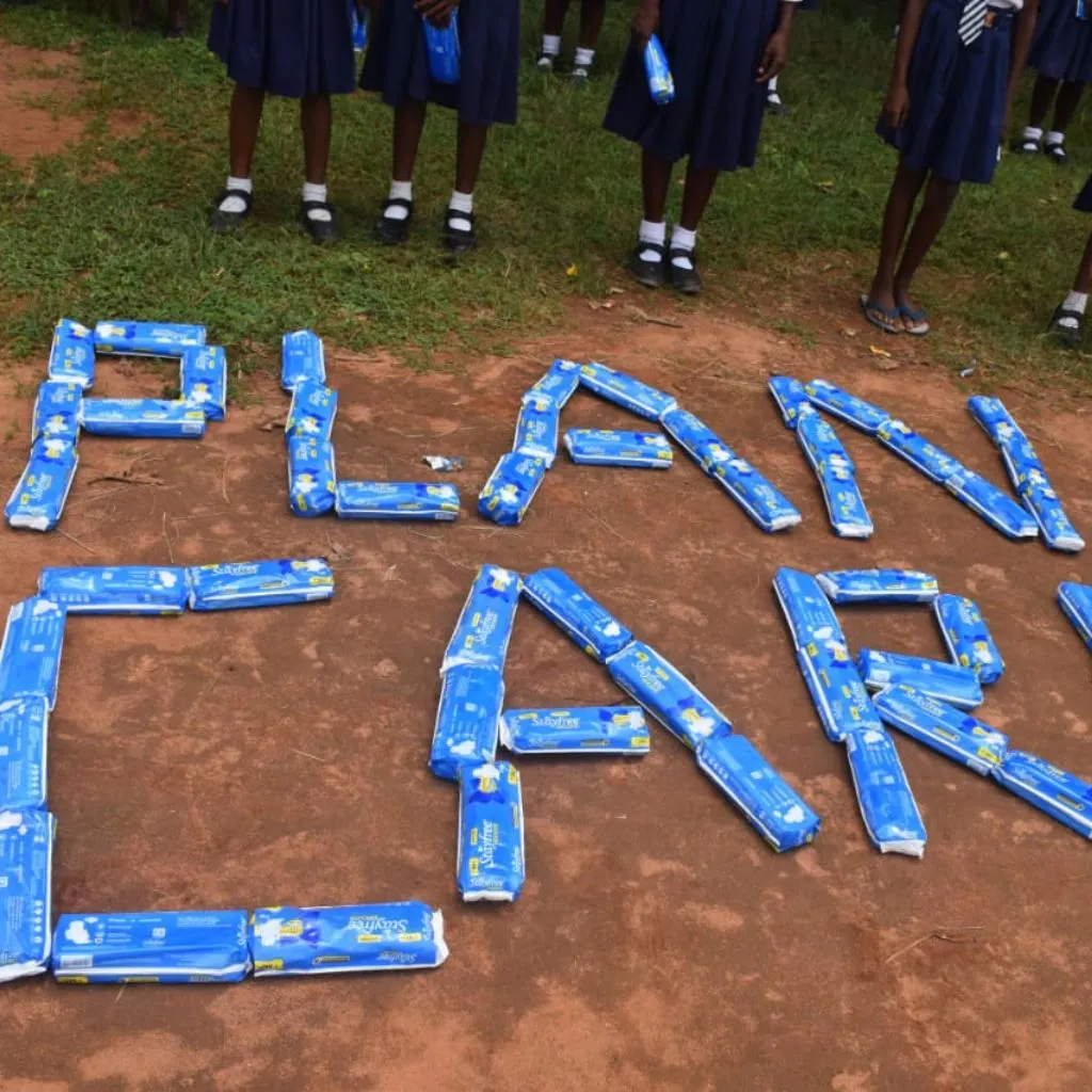 Young girls receiving eco-friendly sanitary pads during PlanCare's awareness session